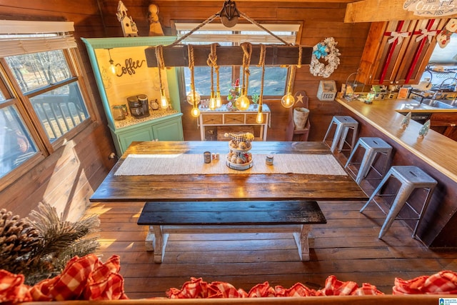 dining room with wooden walls and hardwood / wood-style floors