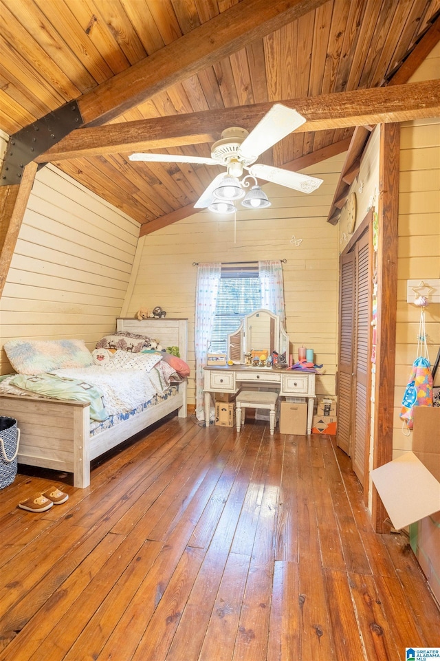 unfurnished bedroom featuring hardwood / wood-style flooring, wood ceiling, ceiling fan, and wood walls