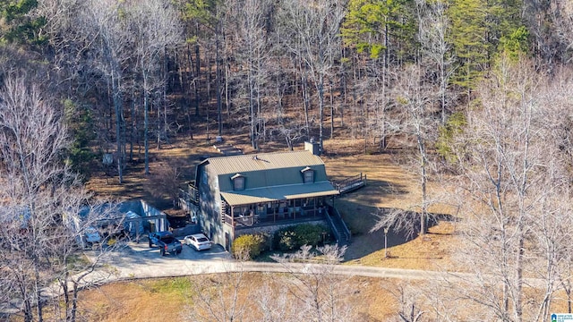 birds eye view of property with a view of trees