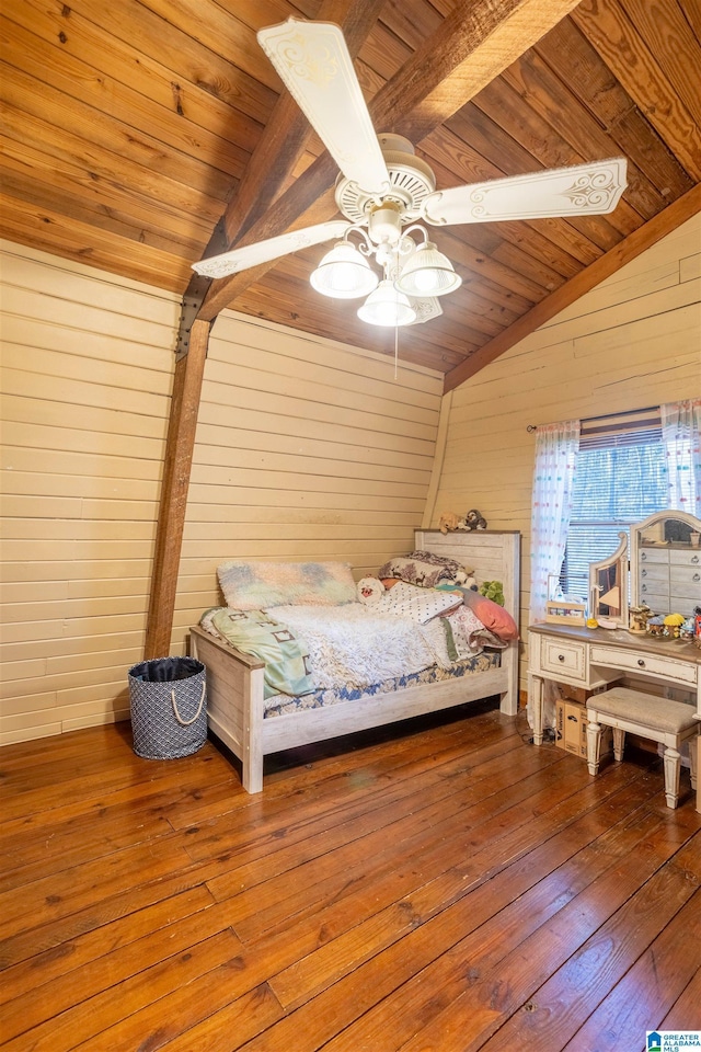 unfurnished bedroom with hardwood / wood-style floors, ceiling fan, and lofted ceiling with beams