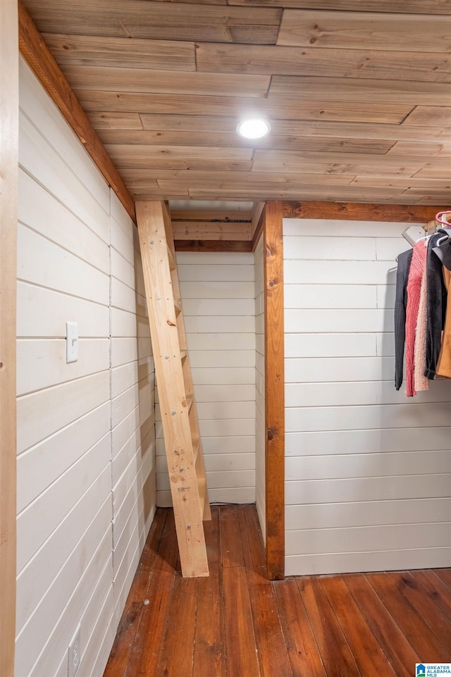 interior space featuring wooden walls, hardwood / wood-style flooring, and wooden ceiling