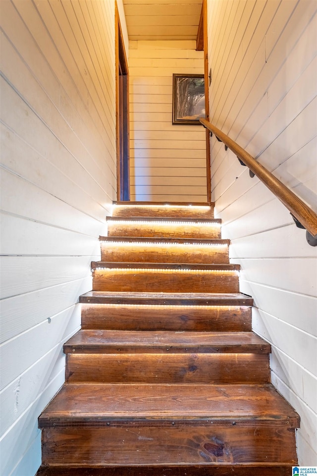 staircase with wood walls