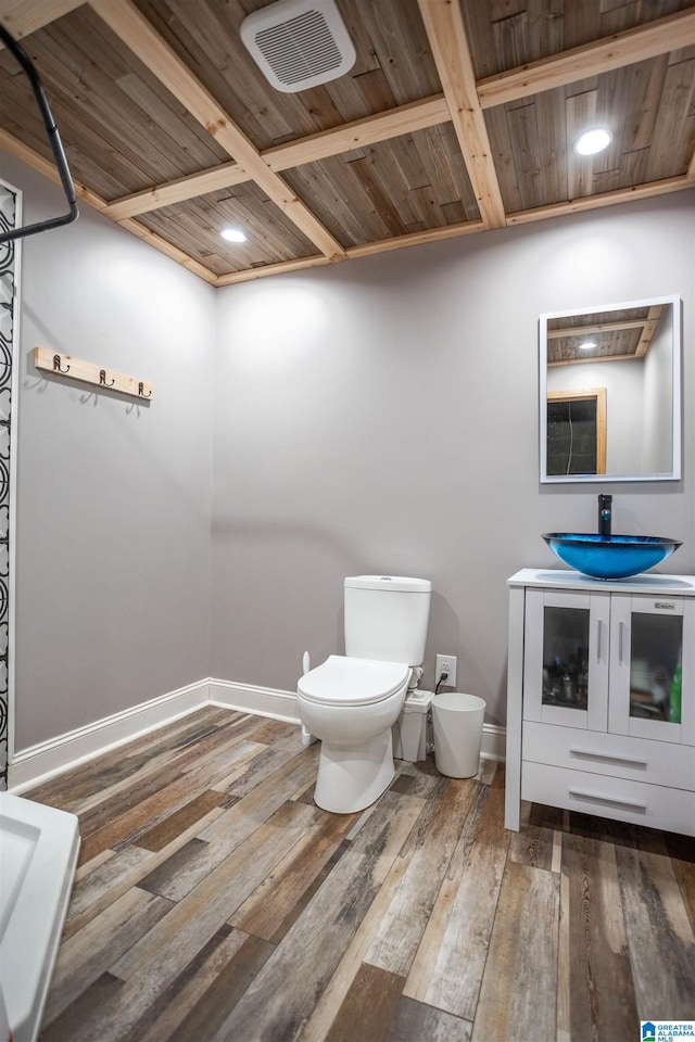 bathroom with hardwood / wood-style flooring, toilet, and wood ceiling