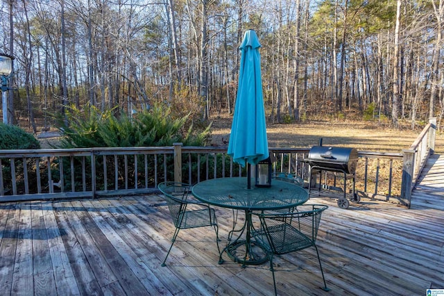 wooden terrace with grilling area and outdoor dining space