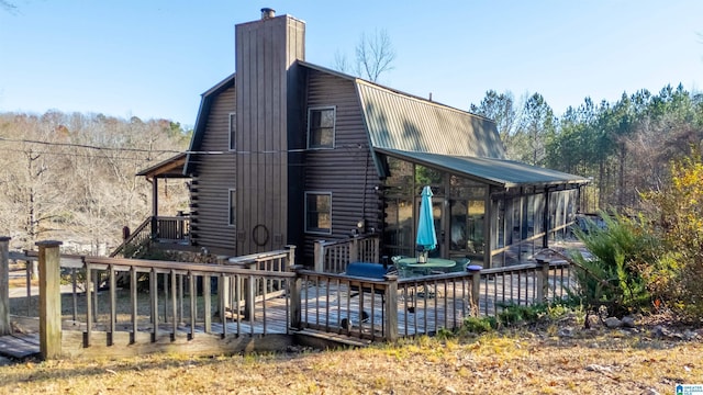 rear view of property with a wooden deck