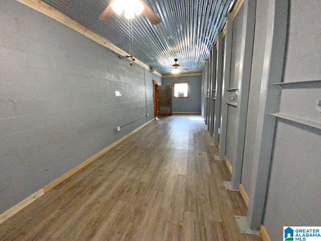 hall with wood finished floors and baseboards