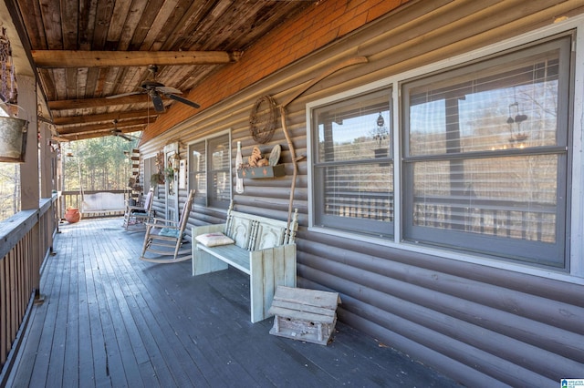 wooden terrace featuring a ceiling fan