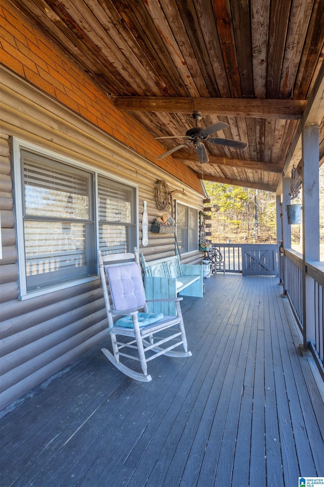 wooden terrace with a ceiling fan and covered porch