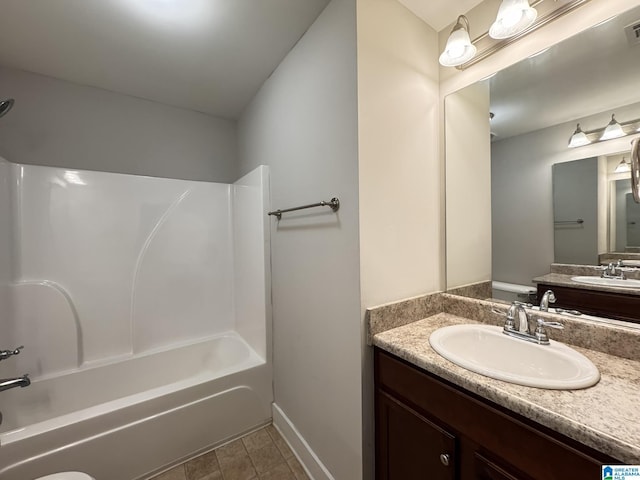 full bathroom with tile patterned flooring, vanity,  shower combination, and toilet