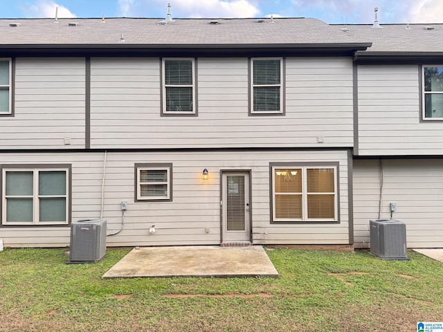 back of house featuring a patio, a lawn, and central air condition unit