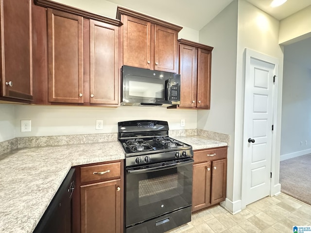 kitchen featuring black appliances and light carpet