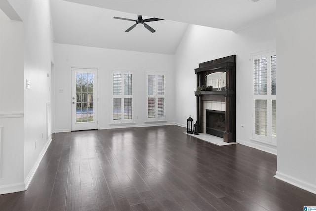 unfurnished living room with a tile fireplace, dark hardwood / wood-style floors, high vaulted ceiling, and ceiling fan