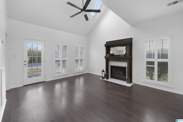 unfurnished living room featuring ceiling fan, wood-type flooring, a fireplace, and high vaulted ceiling