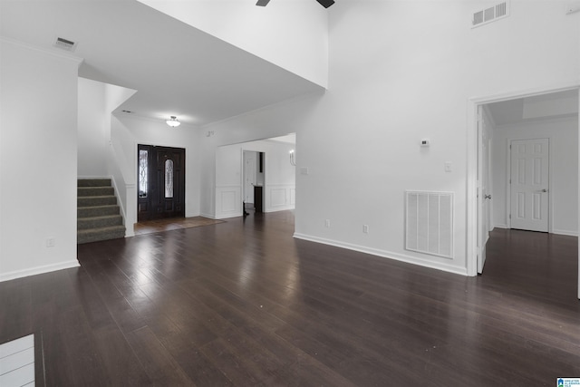 unfurnished living room featuring ceiling fan and dark hardwood / wood-style flooring