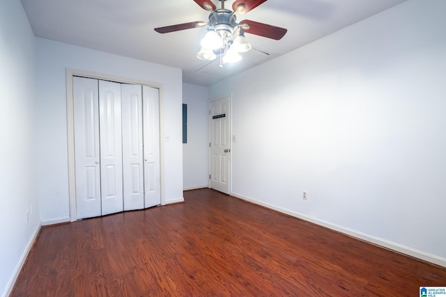 unfurnished bedroom featuring ceiling fan, dark wood-type flooring, and a closet