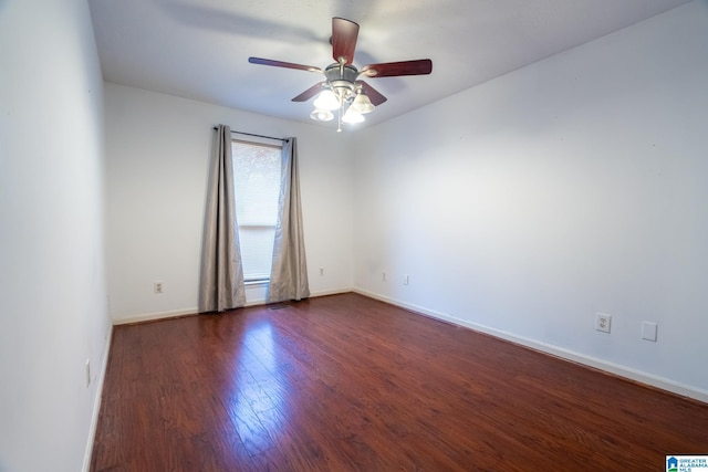 empty room with ceiling fan and dark wood-type flooring