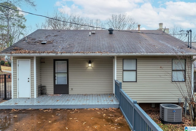 back of property with a deck and central AC unit