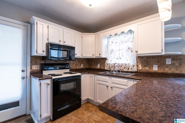 kitchen featuring electric range, white cabinets, and sink