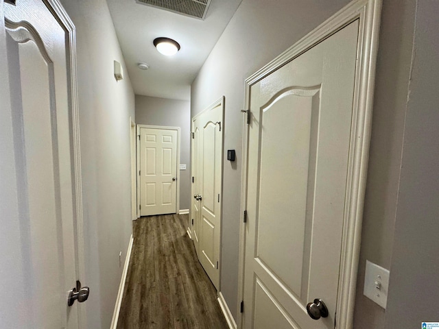 corridor with dark wood-type flooring