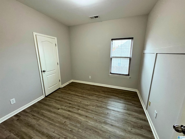 unfurnished room featuring dark hardwood / wood-style floors