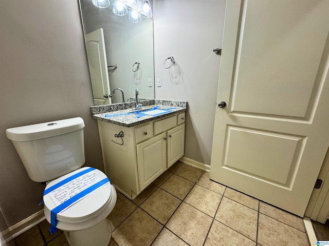 bathroom with tile patterned flooring, vanity, and toilet