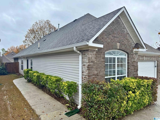 view of side of home with a garage