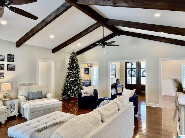 living room featuring lofted ceiling with beams, dark wood-type flooring, and ceiling fan with notable chandelier