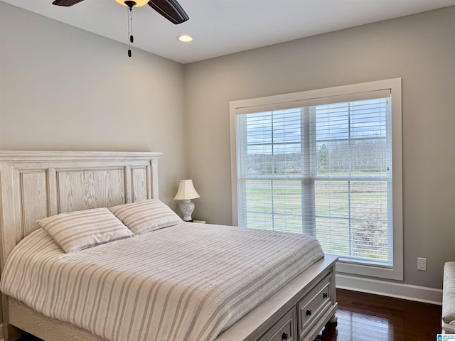 bedroom with ceiling fan and dark wood-type flooring