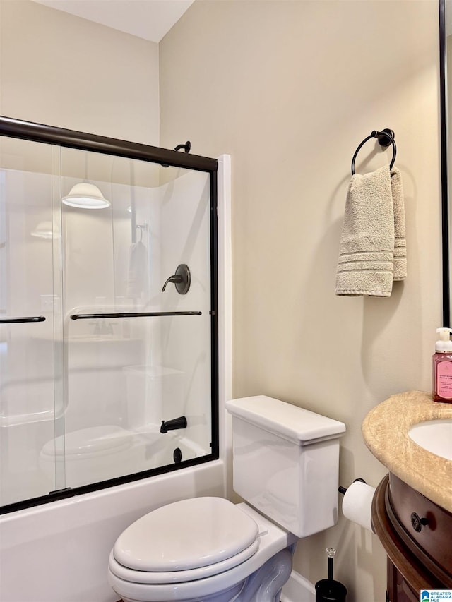 full bathroom featuring vanity, toilet, and bath / shower combo with glass door