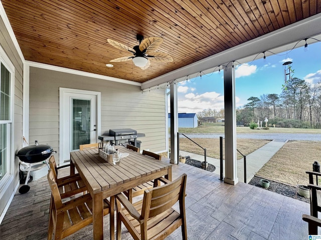 sunroom / solarium with ceiling fan and wood ceiling