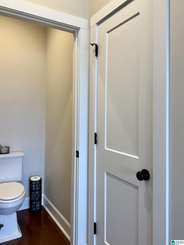 bathroom with wood-type flooring and toilet