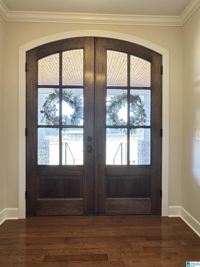 entrance foyer featuring crown molding, a wealth of natural light, and french doors