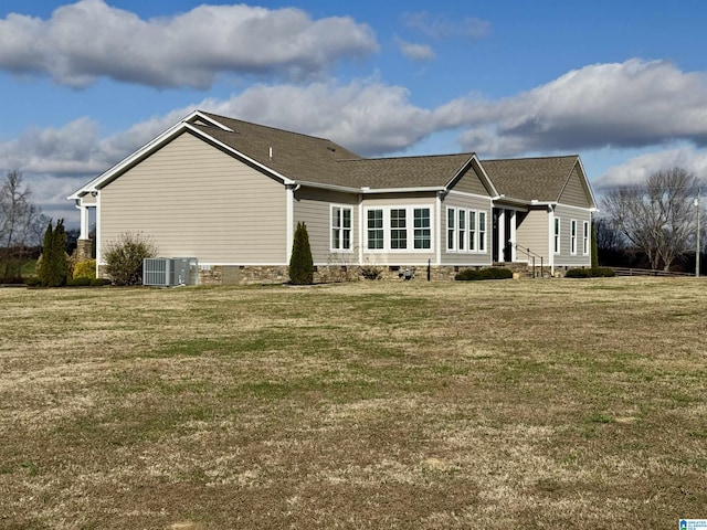 rear view of house featuring a yard and central AC unit