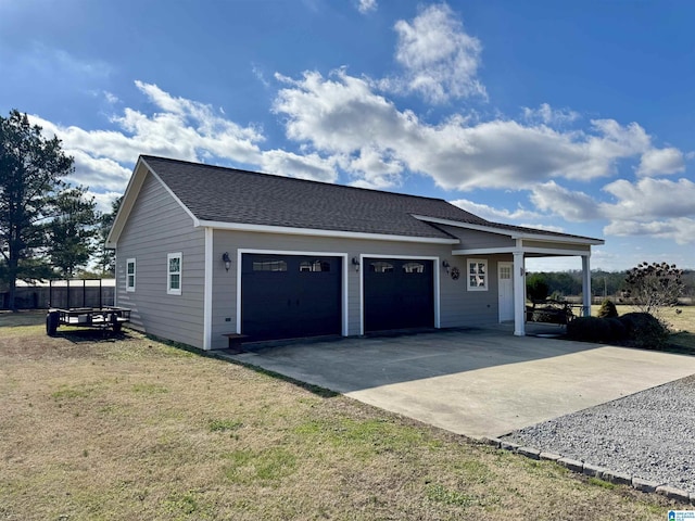 exterior space featuring a garage and a lawn