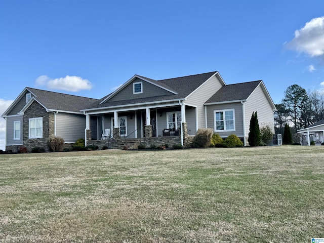 view of front of home with covered porch and a front lawn