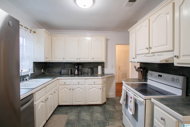 kitchen with white cabinets, stainless steel appliances, tasteful backsplash, and sink