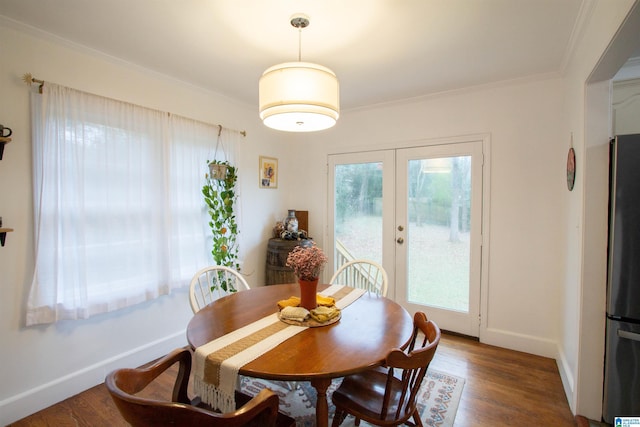 dining room with french doors, dark hardwood / wood-style flooring, and crown molding