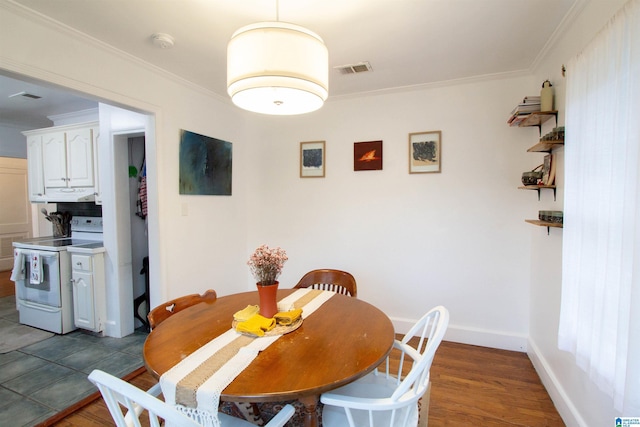 dining area featuring dark hardwood / wood-style floors and ornamental molding