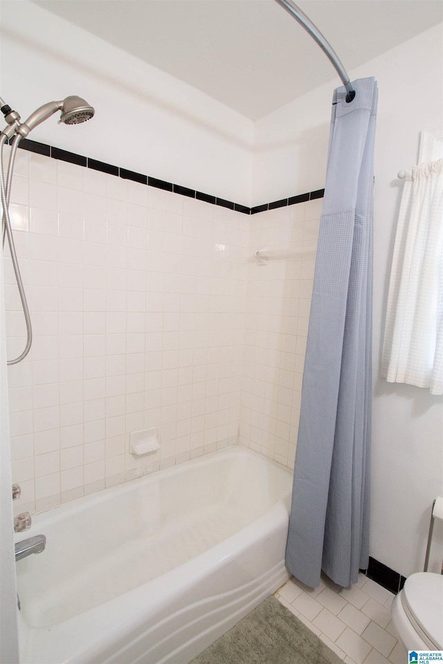 bathroom with tile patterned flooring, toilet, and shower / bath combo with shower curtain