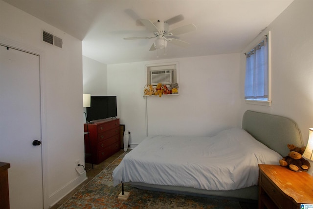 bedroom featuring a wall mounted air conditioner and ceiling fan