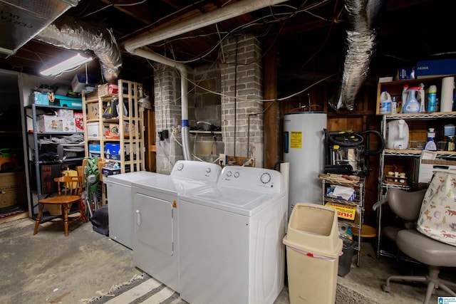 clothes washing area with washing machine and dryer and water heater