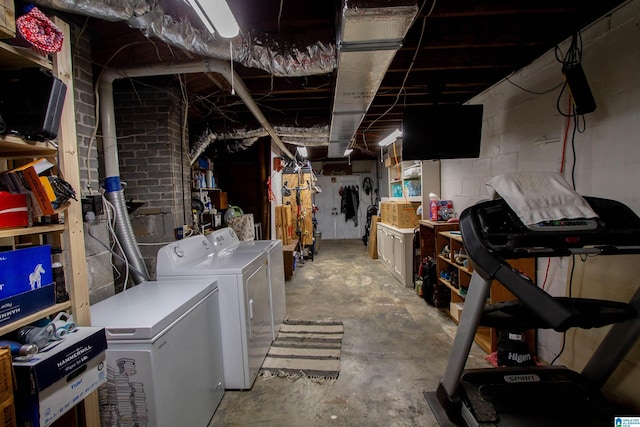 basement with washing machine and clothes dryer and refrigerator