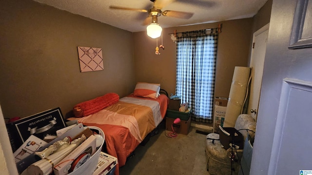 bedroom with ceiling fan and a textured ceiling