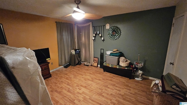 bedroom with light hardwood / wood-style flooring and ceiling fan