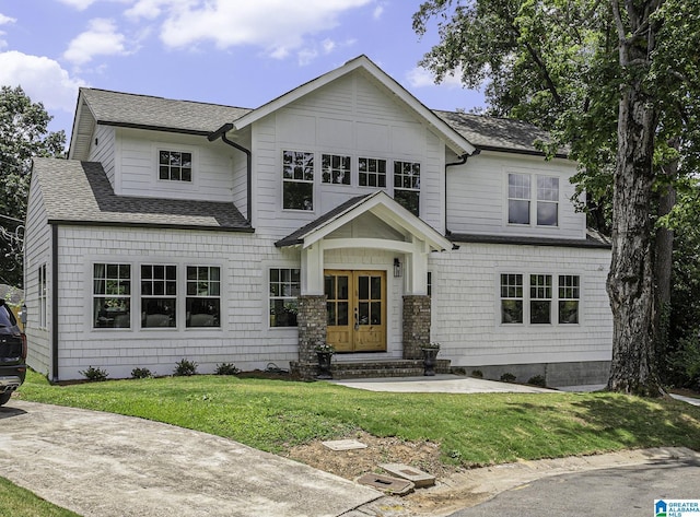 view of front of home featuring french doors and a front lawn