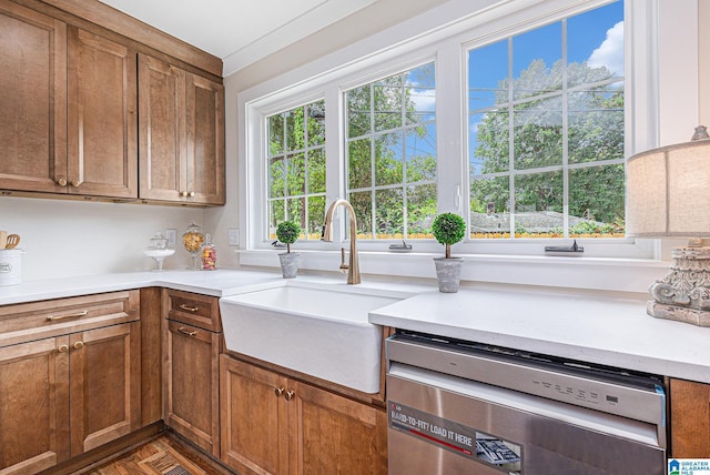 kitchen featuring stainless steel dishwasher, dark parquet flooring, and sink