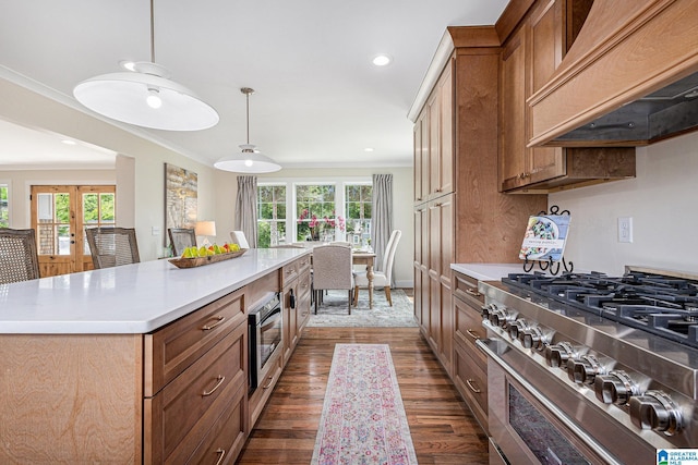 kitchen with a center island, decorative light fixtures, stainless steel stove, custom range hood, and ornamental molding