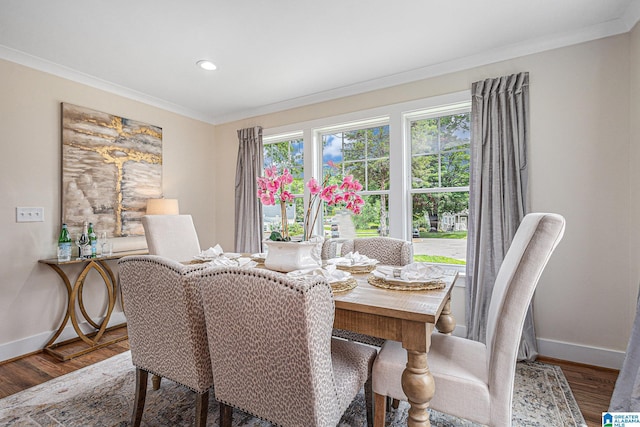 dining room with crown molding and hardwood / wood-style flooring