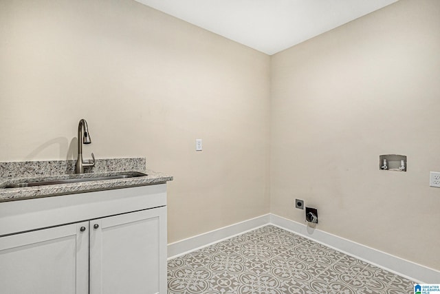 clothes washing area with electric dryer hookup, cabinets, sink, washer hookup, and light tile patterned flooring