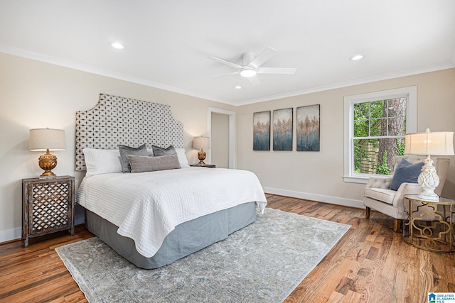 bedroom with hardwood / wood-style floors, ceiling fan, and ornamental molding